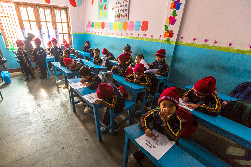 Kathmandu, Nepal - December 24, 2013: Unknown pupils in English class at primary school. Only 50% of  children in Nepal can reach 5 grade.