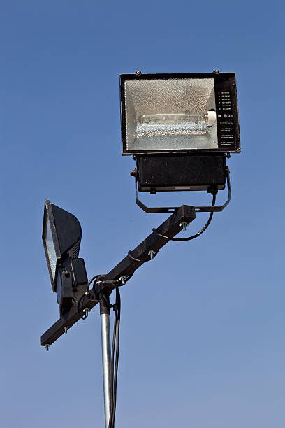 istock Spotlights and mobile stand on blue sky. 466485397