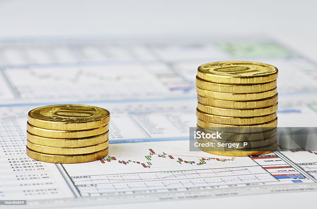 Financial chart and golden coins. Successful trading Financial chart and golden coins. Successful trading.Selective focus Analyzing Stock Photo