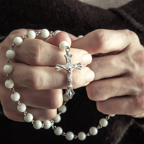 istock Woman  with rosary 466486653
