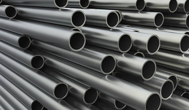 Close-up of stacked metal pipes of varying lengths Metal pipes in perspective titanium stock pictures, royalty-free photos & images