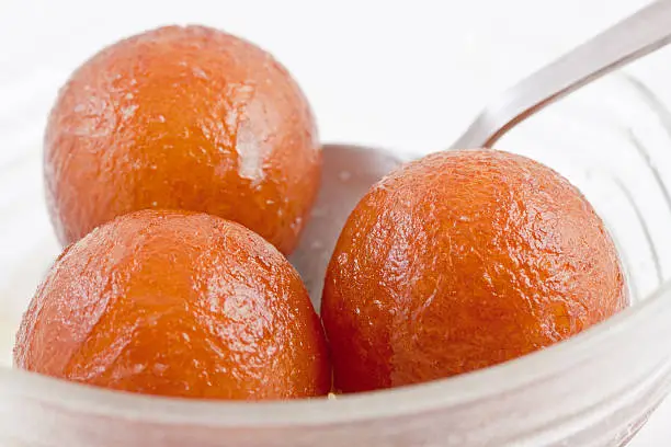 Gulab jamun is a popular dessert in countries of the Indian Subcontinent such as India, Pakistan, Sri Lanka, Nepal and Bangladesh. It is made of a dough consisting mainly of milk solids, traditionally, khoya, an Indian milk product (buffalo milk) is rolled into a ball together with some flour and then deep fried. It is then put into in a sugar syrup flavored with cardamom seeds and rosewater, kewra or saffron.These days, Gulab Jamun powder is also commercially available, so the dessert can be prepared easily. Gulab jamun is common at weddings.