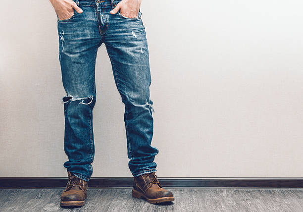istock Legs of man in torn jeans with boots 466491000