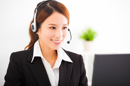 young beautiful asian businesswoman with headset in office