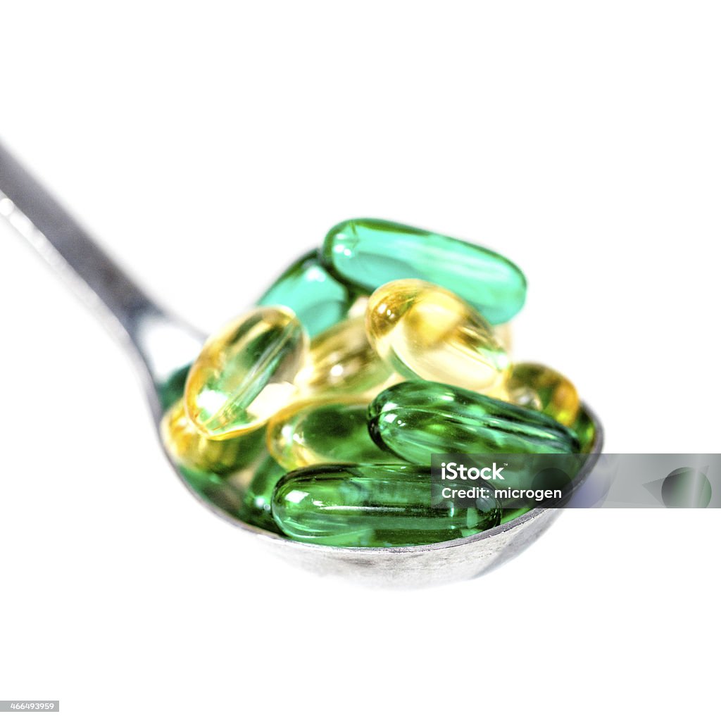 Cucchiaino di cibo di vitamina pillole - Foto stock royalty-free di Bianco