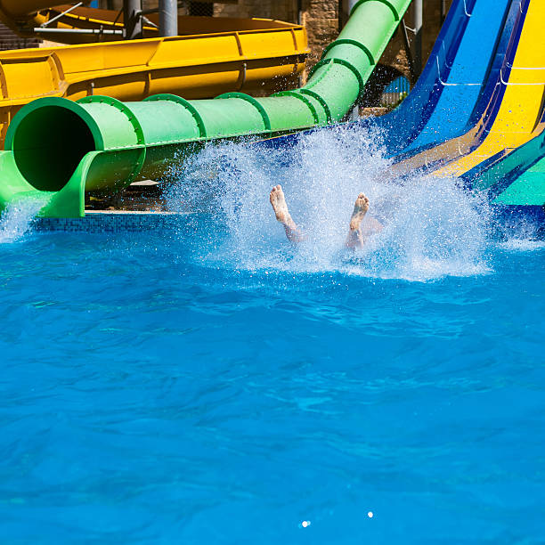 istock Happy woman sliding water park 466496408