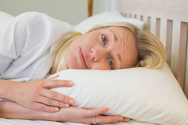 istock Sleepy woman lying in bed 466496648