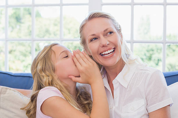 istock Girl sharing secret with mother on sofa 466496652