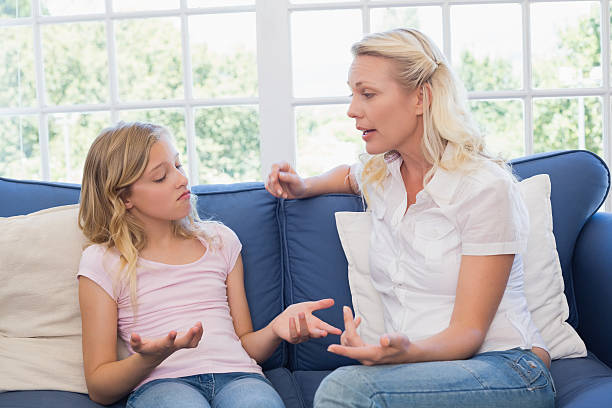 istock Angry mother scolding daughter on sofa 466496838