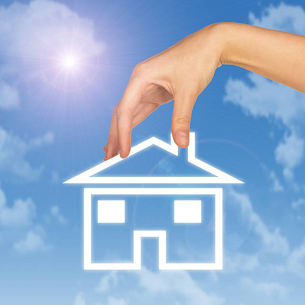 istock Hand holding house icon. Background of sky, clouds and sun 466497194