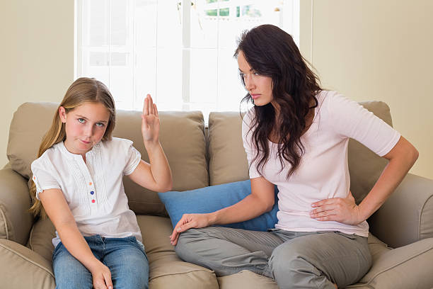 istock Girl showing stop gesture to mother on sofa 466497232