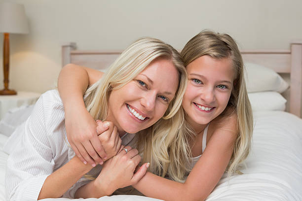 istock Loving mother and daughter lying in bed 466497338