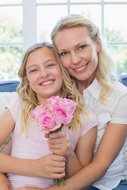 istock Mother and daughter with rose bouquet 466497400