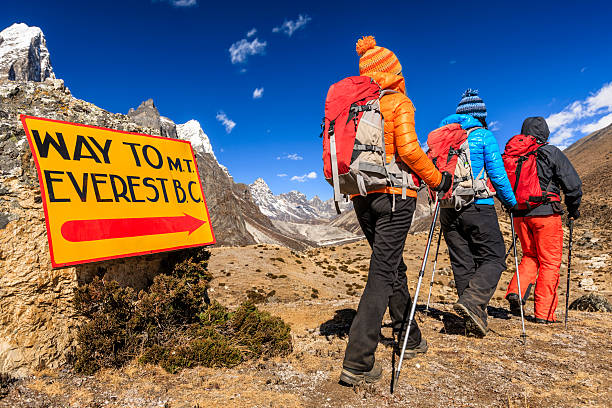 Group of trekkers on the way to Everest Base Camp Group of three trekkers passing signpost "Way to Mount Everest Base Camp" - Mount Everest (Sagarmatha) National Park. This is the highest national park in the world, with the entire park located above 3,000 m ( 9,700 ft). This park includes three peaks higher than 8,000 m, including Mt Everest. Therefore, most of the park area is very rugged and steep, with its terrain cut by deep rivers and glaciers. Unlike other parks in the plain areas, this park can be divided into four climate zones because of the rising altitude.http://bhphoto.pl/IS/nepal_380.jpg icefall stock pictures, royalty-free photos & images