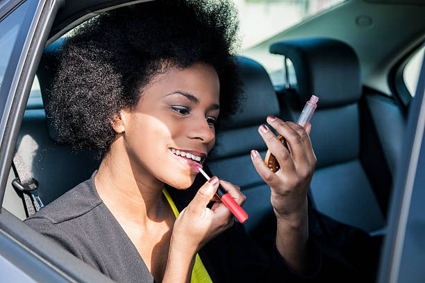 istock Woman applying make up in the car 466500252