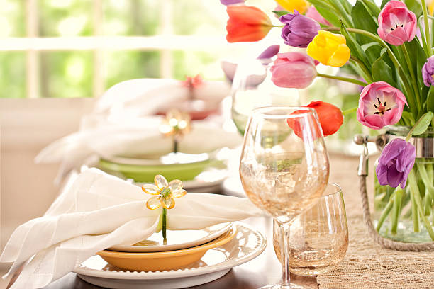 istock Spring dining table, place settings with tulip bouquet centerpiece 466500278