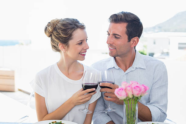 istock Loving couple with wine glasses looking at each other 466502414