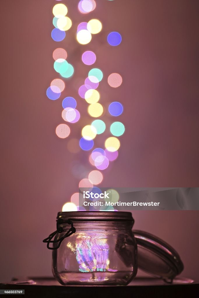 Released Dreams Lights floating out of an open glass jar. Jar Stock Photo