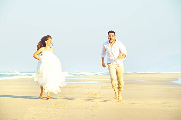 istock happy couple at beach 466504916