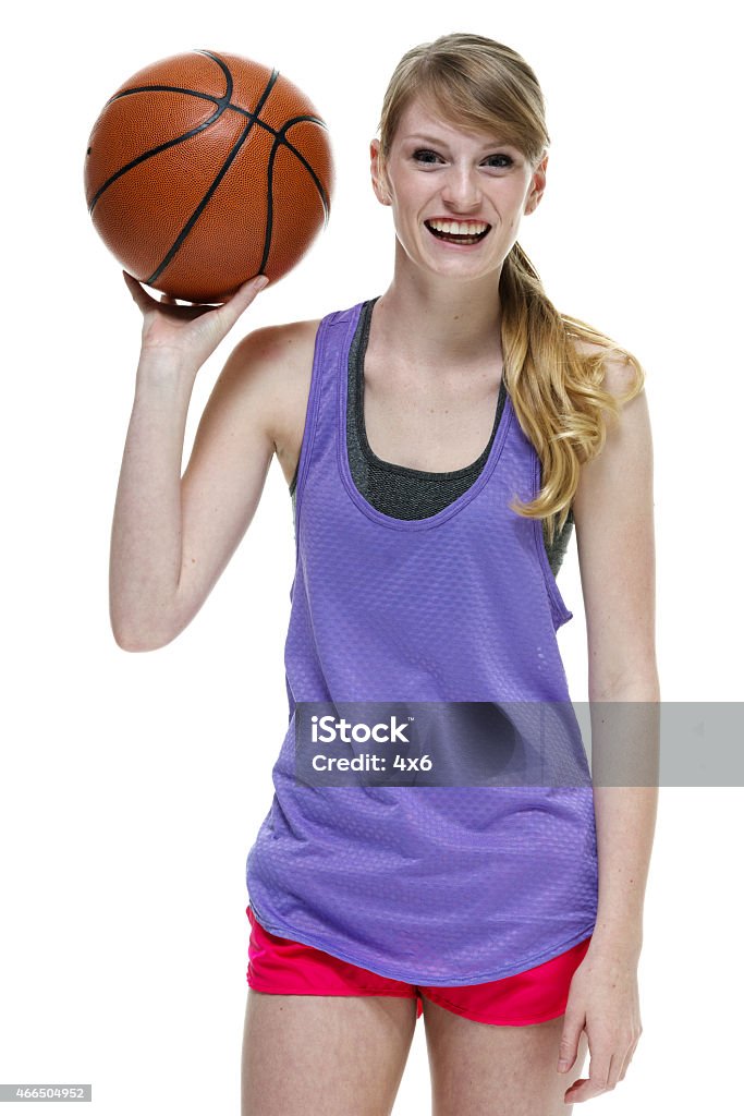 Cheerful female athlete holding basketball Cheerful female athlete holding basketballhttp://www.twodozendesign.info/i/1.png 14-15 Years Stock Photo