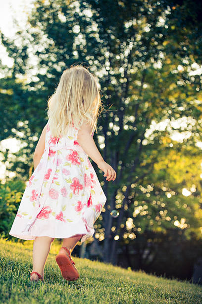 istock little girl running with sunset 466505017