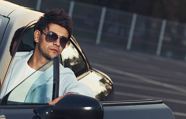 istock Handsome young man sit in his car 466505165