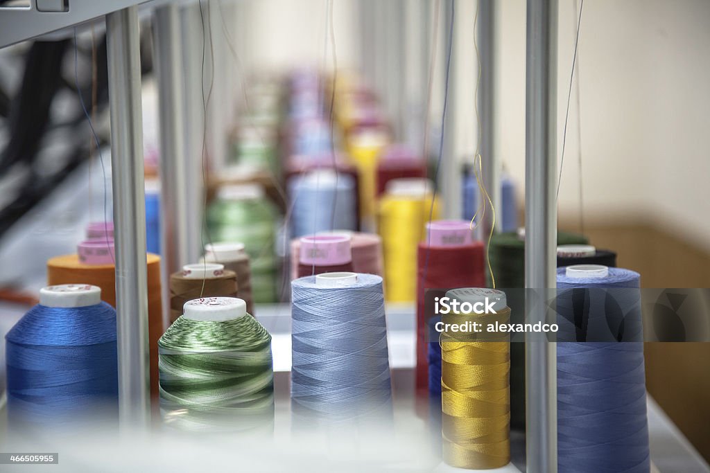 Colorful thread reels sitting in an orderly fashion Colorful reels of threads background - interior of industrial textile factory Art And Craft Stock Photo