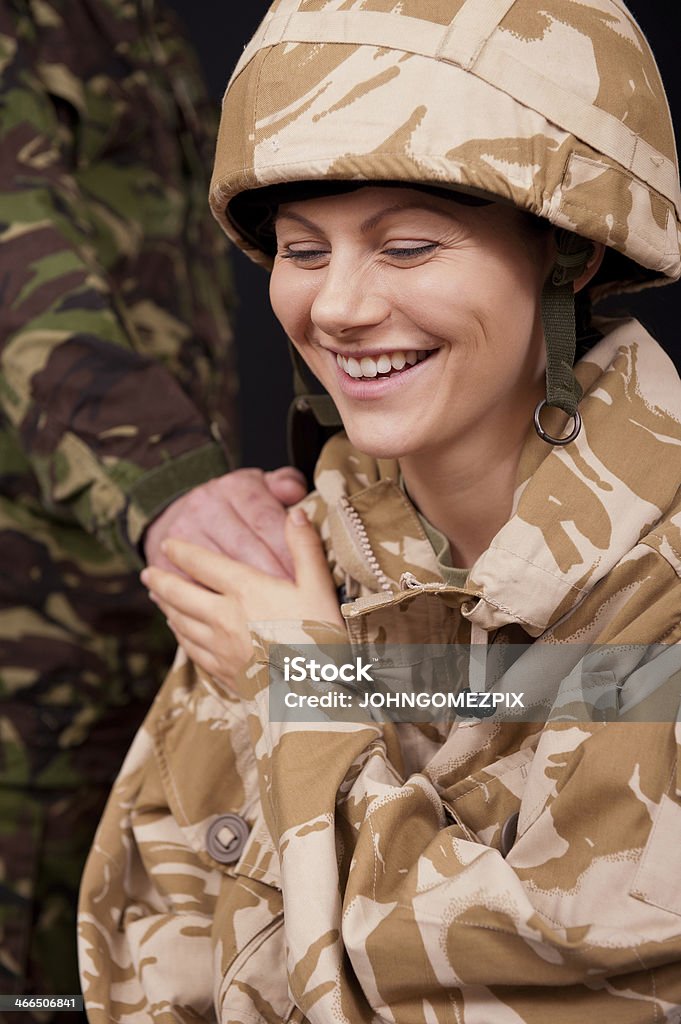 Laughing Female Soldier Portrait of a laughing young female British soldier with a male soldier's hand on her shoulder, British Military Stock Photo