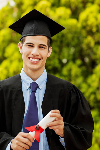 istock Graduate Male Student Holding Diploma On Campus 466507417