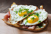 slice of rustic bread with ham  and fried eggs