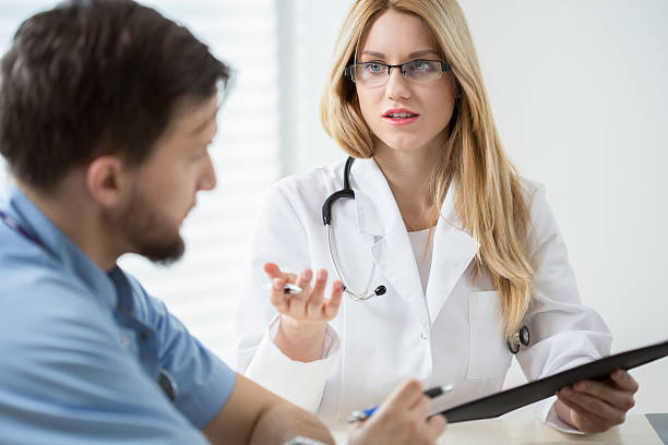 istock Intern consulting with other doctor 466509076