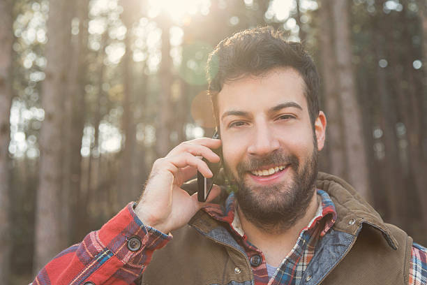 istock Bearded lumbersexual guy on the phone 466509464