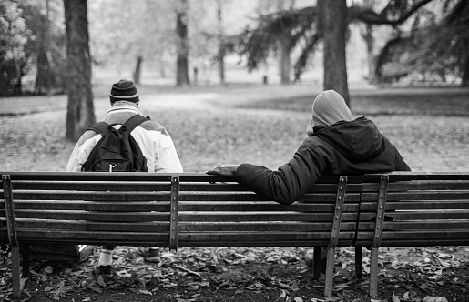 Milan, Italy - November 25, 2014: View of two black people sitting on the bench on November 24, 2014