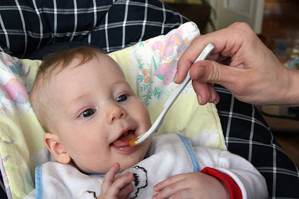 istock Baby eating first food 466513479