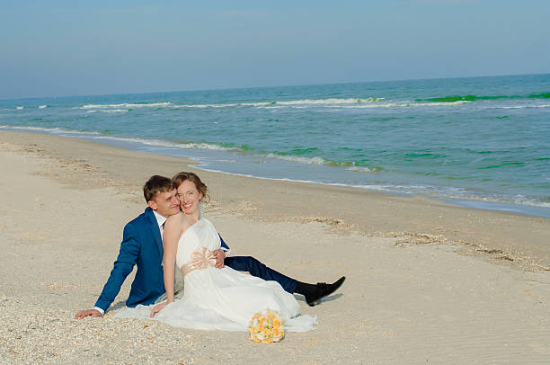 istock Young bride and groom on the beach 466513646