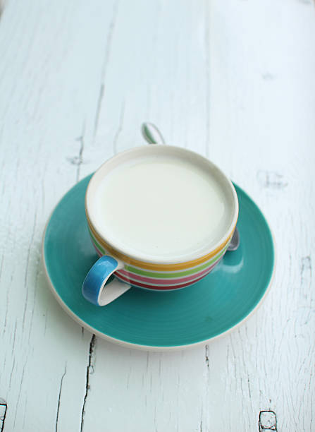 istock Hot goat milk cup on white grunge board 466514941