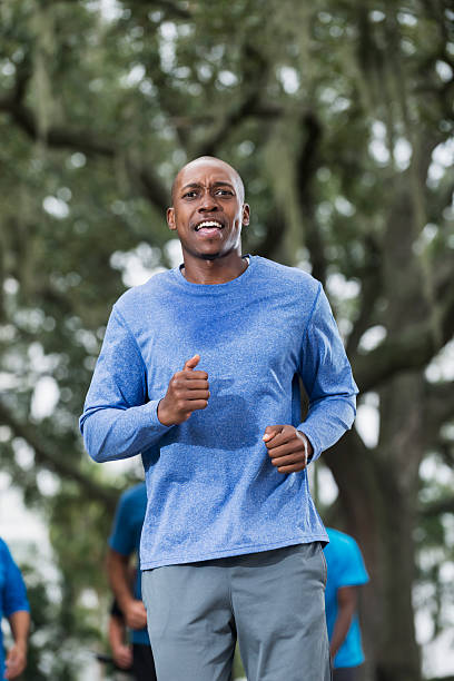 istock Young African American man running in park 466519268