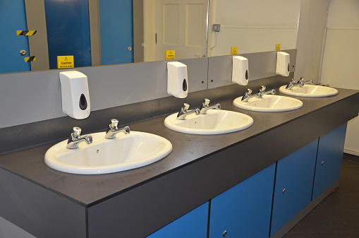four sinks in a public convenience room