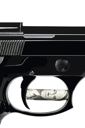Macro of gun trigger with One American Dollar front white background. Adobe RGB.