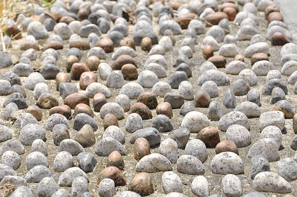 istock Pebble Stone On Pavement For Foot Reflexology Pathway 466520484