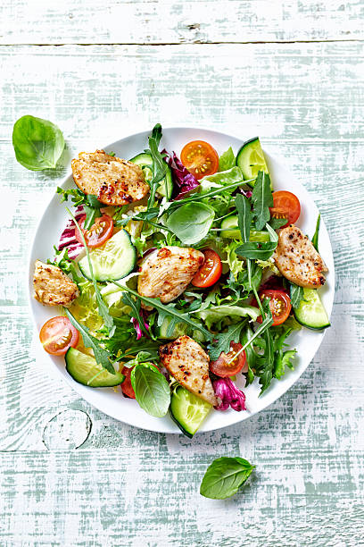 Chicken salad with leaf vegetables and cherry tomatoes stock photo