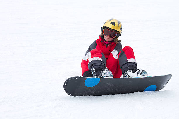 Little girl snowboarder in French Alps stock photo