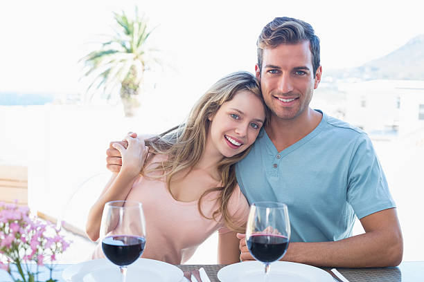 istock Loving couple with wine glasses at dining table 466524164