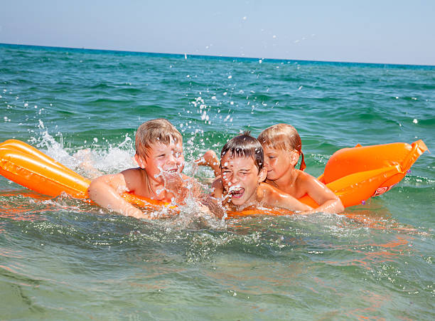 istock Children playing on a inflatable mattress 466531444