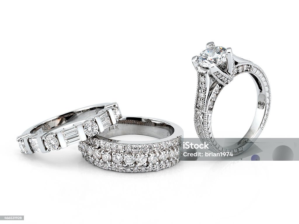 White Gold Diamond Rings Beautiful Diamond Eternity Bands along with an Engagement Ring on white background.  Jewelry Stock Photo
