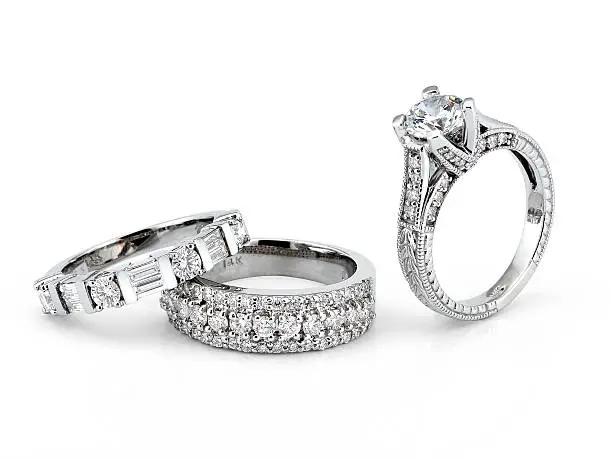 Beautiful Diamond Eternity Bands along with an Engagement Ring on white background. 