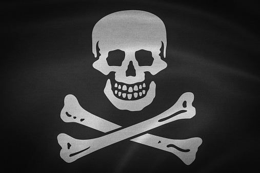 Black pirate flag with skull and crossbones symbol 