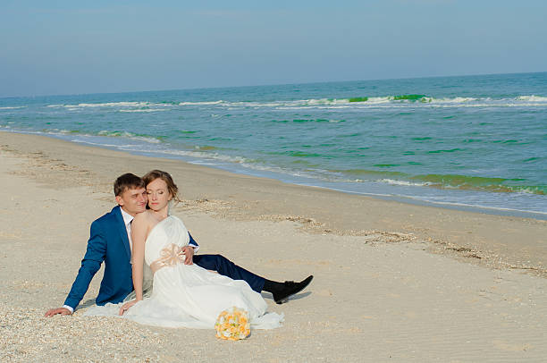istock Young bride and groom on the beach 466535646