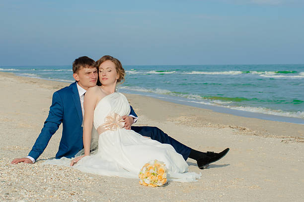 istock Young bride and groom on the beach 466535692