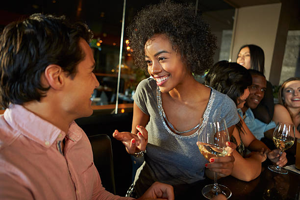 istock Couple Enjoying Drink At Bar With Friends 466539971